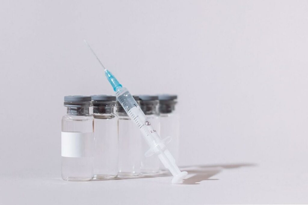 covid vaccine bottles and syringe